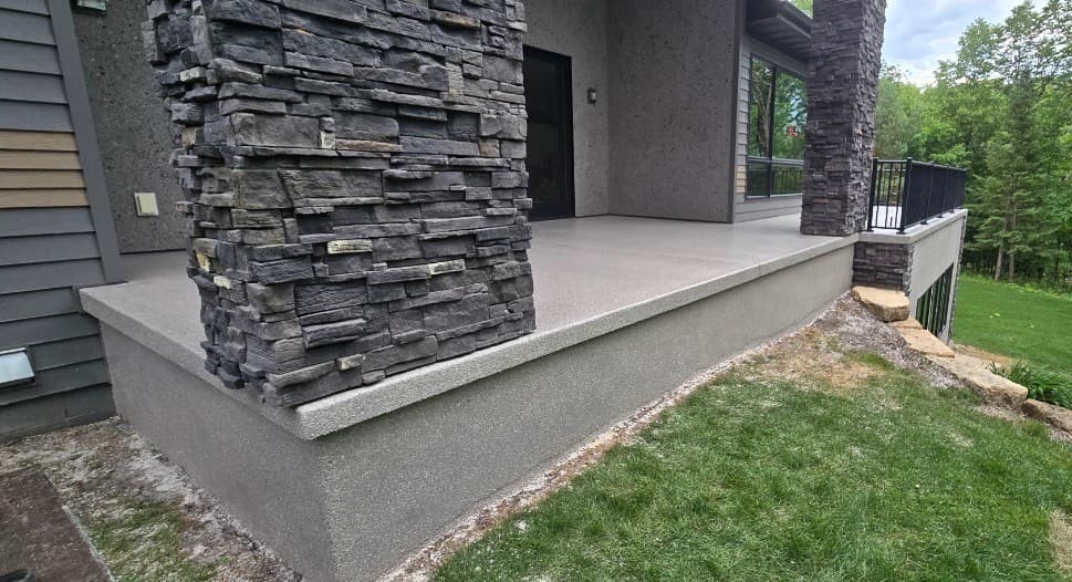 Luxury stone-column porch with polyaspartic coating